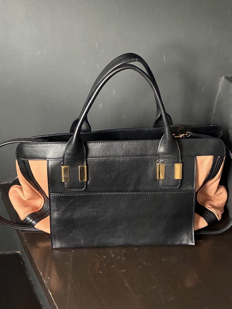Chloé Alice Two-Tone Leather Satchel (Category: Luxury Bags & Wallets) located in Pasig City. Submitted by alvinthedecluttererist (Listing ID 1466024460, Image 3). Description: - Authentic Chloé Alice handbag in black and light pink leather - Elegant gold-tone hardware and front slip pocket with Chloé logo stamp - Structured double top handles plus a detachable strap for versatile wear - Secure zip top closure with a spacious fabric-lined interio