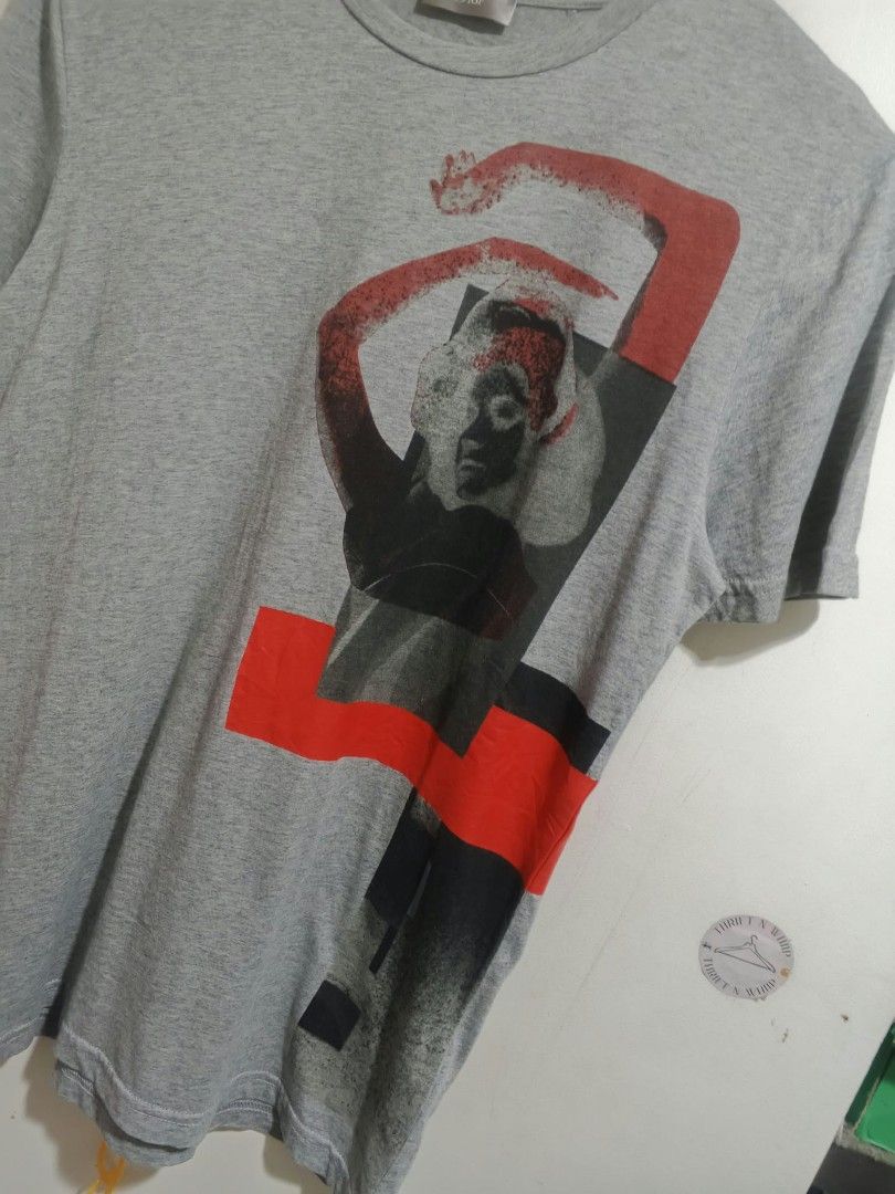Christian Dior Grey Graphic Tee (Category: Tshirts & Polo Shirts ) located in Kabankalan. Submitted by hiddenjunk_ph (Listing ID 1466104186, Image 2). Description: - Brand: Made in Italy - Size: S - Material: 100% cotton - Color: Grey with red and black front graphic print - Design: Crew neck, short sleeves - Condition: Clean, vibrant colors with intact tags.