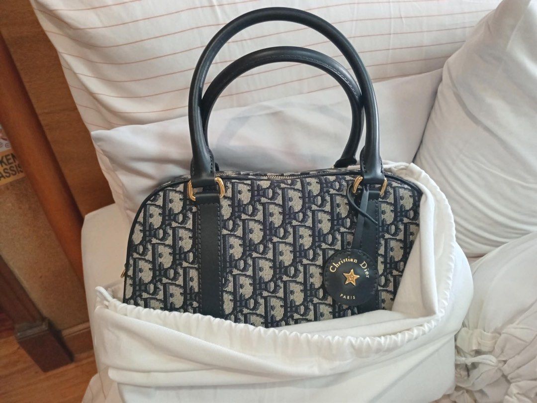 Christian Dior Oblique Monogram Bowling Bag (Category: Luxury Bags & Wallets) located in Taguig. Submitted by byebyebabies (Listing ID 1466086539, Image 1). Description: - Authentic Christian Dior bowling bag in classic blue oblique monogram canvas - Elegant black leather handles and trim with shiny gold hardware - Iconic hanging circular leather charm featuring a gold star and 'Christian Dior Paris' lettering - Secure top zipper closure with a s