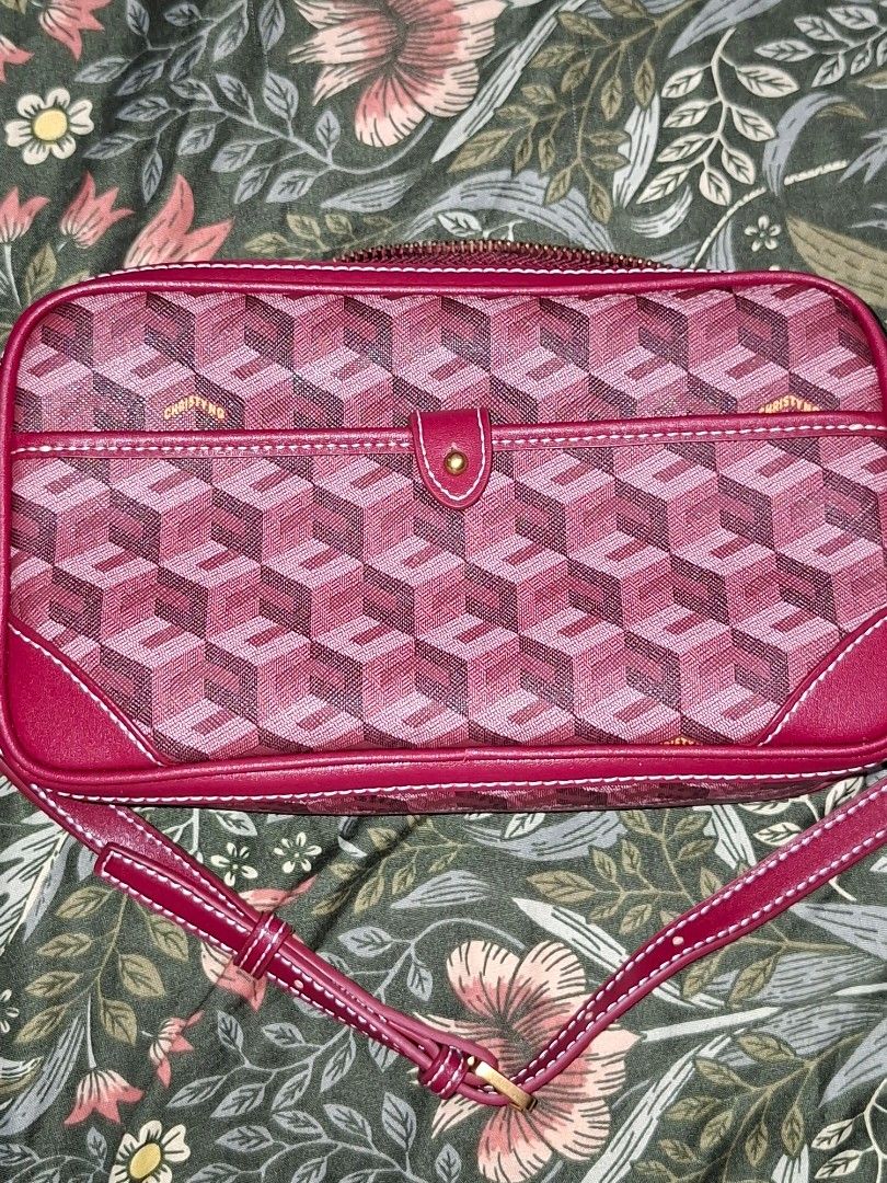 Christy Ng Red Monogram Crossbody Bag (Category: Luxury Bags & Wallets) located in Manila. Submitted by mialiurshop (Listing ID 1465990495, Image 2). Description: - Brand: Christy Ng - Style: Crossbody bag with all-over geometric cube monogram pattern - Color: Red with gold-tone hardware - Closure: Secure zip closure and front flap pocket with button closure - Strap: Adjustable matching shoulder strap - Interior: Clean burgundy fabric lining with