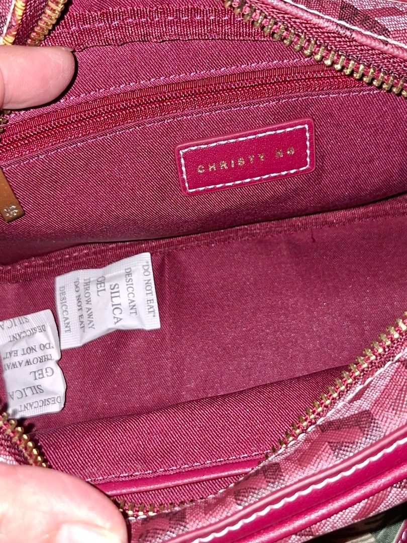 Christy Ng Red Monogram Crossbody Bag (Category: Luxury Bags & Wallets) located in Manila. Submitted by mialiurshop (Listing ID 1465990495, Image 3). Description: - Brand: Christy Ng - Style: Crossbody bag with all-over geometric cube monogram pattern - Color: Red with gold-tone hardware - Closure: Secure zip closure and front flap pocket with button closure - Strap: Adjustable matching shoulder strap - Interior: Clean burgundy fabric lining with