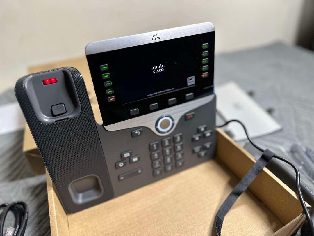 Cisco IP Phone with Display Screen and Handset (Category: Office & Business Technology) located in Manila. Submitted by bacsaljose40805 (Listing ID 1466027215, Image 1). Description: - Features a large color display screen, keypad, and programmable line buttons - Powers on successfully with the Cisco logo visible on screen - Comes complete with the original handset and branded packaging box - Ideal upgrade for your office, home office, or remote 