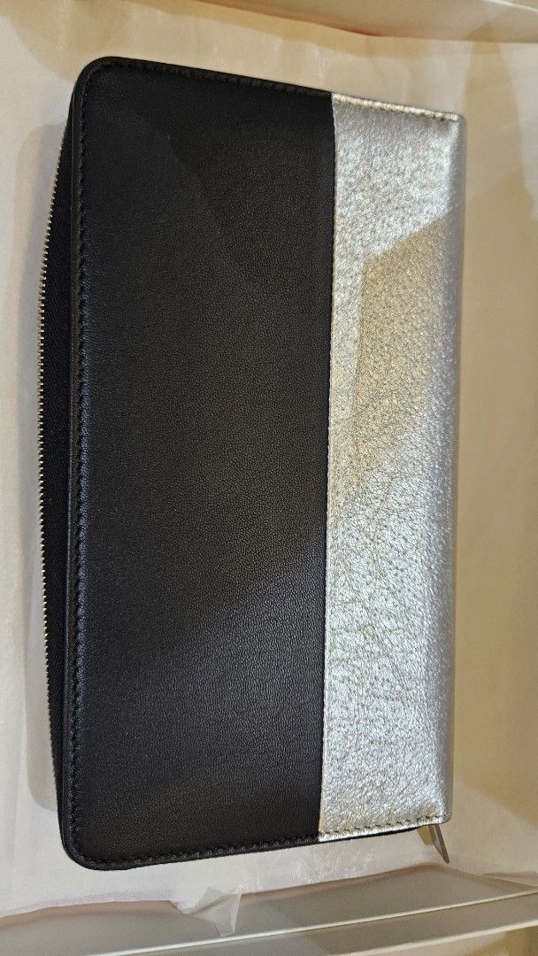Céline Large Zip Around Wallet Black and Silver (Category: Luxury Bags & Wallets) located in Pasig City. Submitted by krist1na092 (Listing ID 1466098838, Image 3). Description: Description BRAND NEW / NEVER USED CÉLINE LARGE ZIP-AROUND WALLET Beautiful older-logo CÉLINE wallet in a striking black and metallic silver combination. Crafted in 100% calfskin leather with a 100% viscose lining, as indicated on the original Céline material tag. Elegant,
