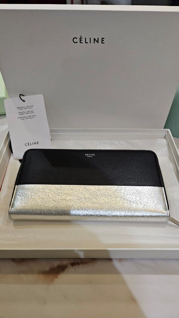 Céline Large Zip Around Wallet Black and Silver (Category: Luxury Bags & Wallets) located in Pasig City. Submitted by krist1na092 (Listing ID 1466098838, Image 2). Description: Description BRAND NEW / NEVER USED CÉLINE LARGE ZIP-AROUND WALLET Beautiful older-logo CÉLINE wallet in a striking black and metallic silver combination. Crafted in 100% calfskin leather with a 100% viscose lining, as indicated on the original Céline material tag. Elegant,