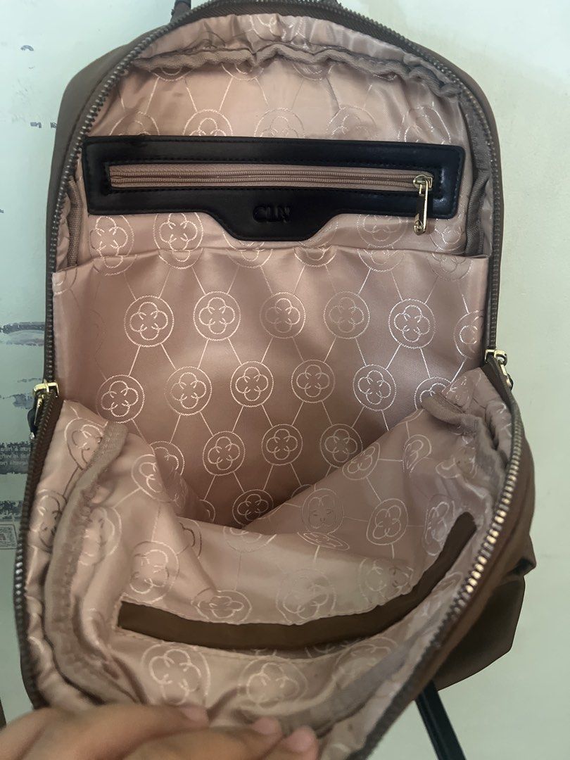 CLN Brown Nylon Backpack with Drawstring and Multiple Pockets (Category: Backpacks) located in Caloocan City. Submitted by shetravels20 (Listing ID 1465962194, Image 2). Description: Only issue: Wornout sa handle ng bag. Original price: 2499 in CLN store Details: Brown CLN backpack made of durable nylon material. Includes a front pocket with a drawstring detail and black strap accents. Main compartment opens wide with a zipper, lined with pattern