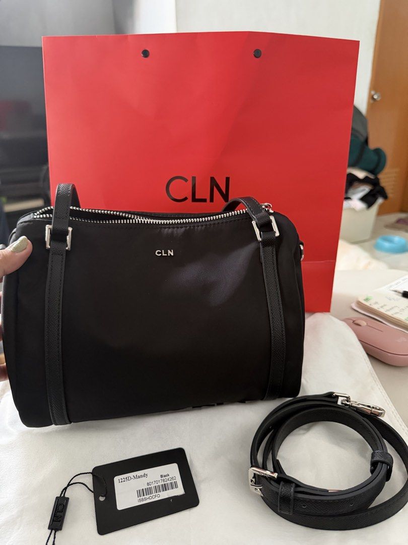 CLN Mandy Black Nylon Handbag (Category: Shoulder Bags) located in Tanza. Submitted by shopatbrandsandstuff (Listing ID 1465961724, Image 1). Description: - Brand: CLN Mandy - Color: Black nylon with striking silver hardware and front logo lettering - Versatile carry: Double top handles and a detachable, adjustable crossbody strap - Storage: Main zippered compartment plus a handy external back zippered pocket - Structure: Clean, structured base t