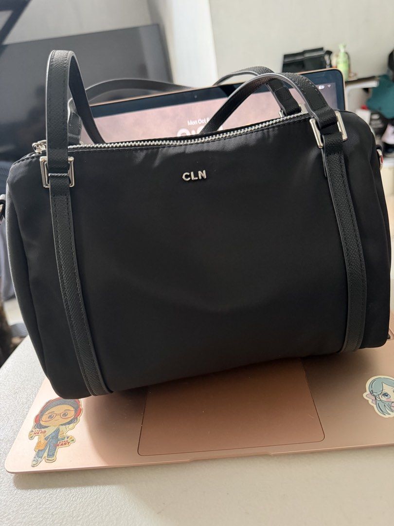 CLN Mandy Black Nylon Handbag (Category: Shoulder Bags) located in Tanza. Submitted by shopatbrandsandstuff (Listing ID 1465961724, Image 2). Description: - Brand: CLN Mandy - Color: Black nylon with striking silver hardware and front logo lettering - Versatile carry: Double top handles and a detachable, adjustable crossbody strap - Storage: Main zippered compartment plus a handy external back zippered pocket - Structure: Clean, structured base t