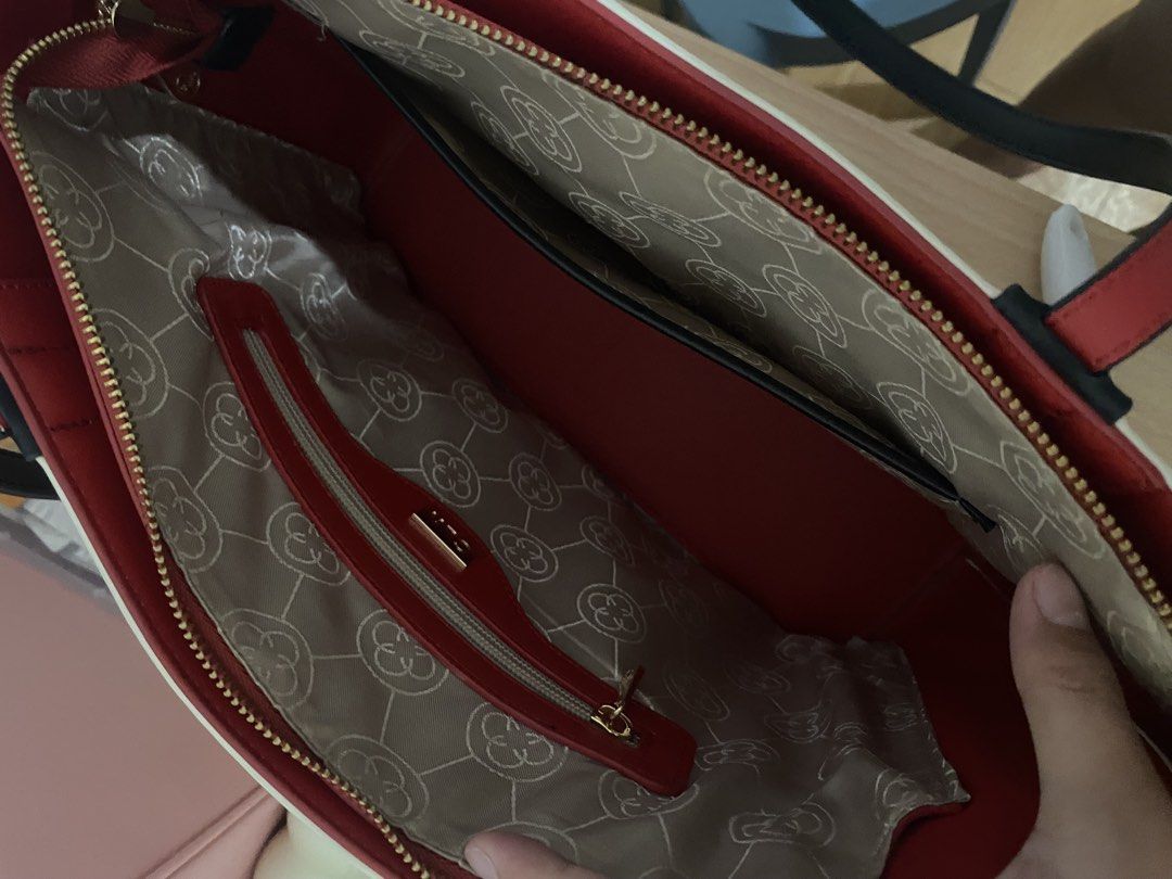 CLN monogram tote bag with red interior and charm (Category: Tote Bags) located in Manila. Submitted by stormiegray (Listing ID 1465981719, Image 3). Description: - Brand: CLN - Design: Monogram print with chic black and red colorway - Straps: Black shoulder straps with contrasting red backing - Closure: Secure zipped main compartment - Interior: Red fabric lining with convenient zipped and slip pockets - Hardware: Premium gold-toned hardware and