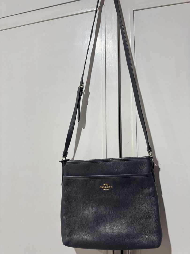 Coach Black Leather Crossbody Bag (Category: Cross-body Bags) located in Bulacan. Submitted by jodayyyyyy (Listing ID 1466117715, Image 1). Description: - Authentic Coach crossbody bag in classic black pebble leather - Elegant gold-tone hardware with front logo stamp and slip pocket - Secure zip closure opening to a clean dark fabric lining with inner creed patch - Comfortable, adjustable leather shoulder strap included - Condition: Good pre-love