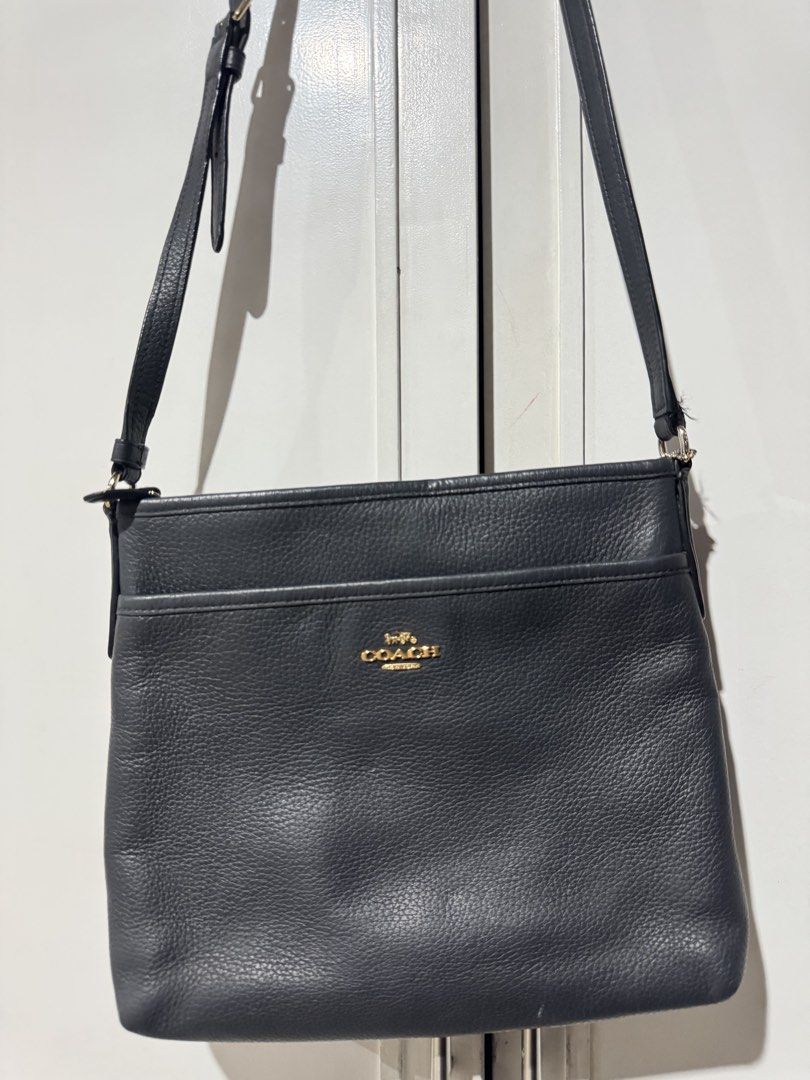 Coach Black Leather Crossbody Bag (Category: Cross-body Bags) located in Bulacan. Submitted by jodayyyyyy (Listing ID 1466117715, Image 2). Description: - Authentic Coach crossbody bag in classic black pebble leather - Elegant gold-tone hardware with front logo stamp and slip pocket - Secure zip closure opening to a clean dark fabric lining with inner creed patch - Comfortable, adjustable leather shoulder strap included - Condition: Good pre-love
