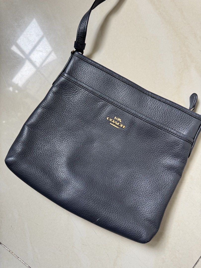 Coach Black Leather Crossbody Bag (Category: Cross-body Bags) located in Bulacan. Submitted by jodayyyyyy (Listing ID 1466117715, Image 3). Description: - Authentic Coach crossbody bag in classic black pebble leather - Elegant gold-tone hardware with front logo stamp and slip pocket - Secure zip closure opening to a clean dark fabric lining with inner creed patch - Comfortable, adjustable leather shoulder strap included - Condition: Good pre-love
