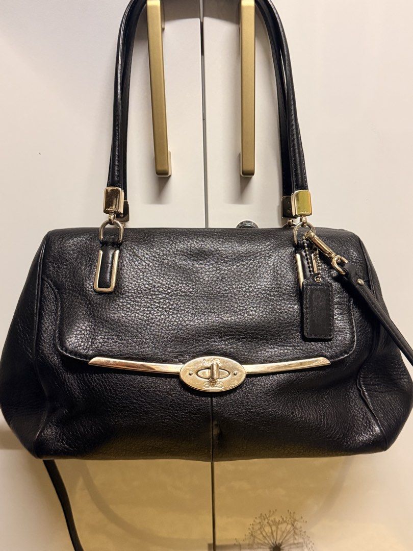 Coach Black Leather Shoulder Bag with Gold Hardware (Category: Luxury Bags & Wallets) located in Zamboanga. Submitted by bags2bags2bags (Listing ID 1465980900, Image 1). Description: - Authentic Coach black pebble leather shoulder bag - Elegant gold turnlock closure and hardware - Versatile styling with double straps and a detachable long strap - Includes the classic leather hangtag - Spacious interior easily holds all daily essentials.