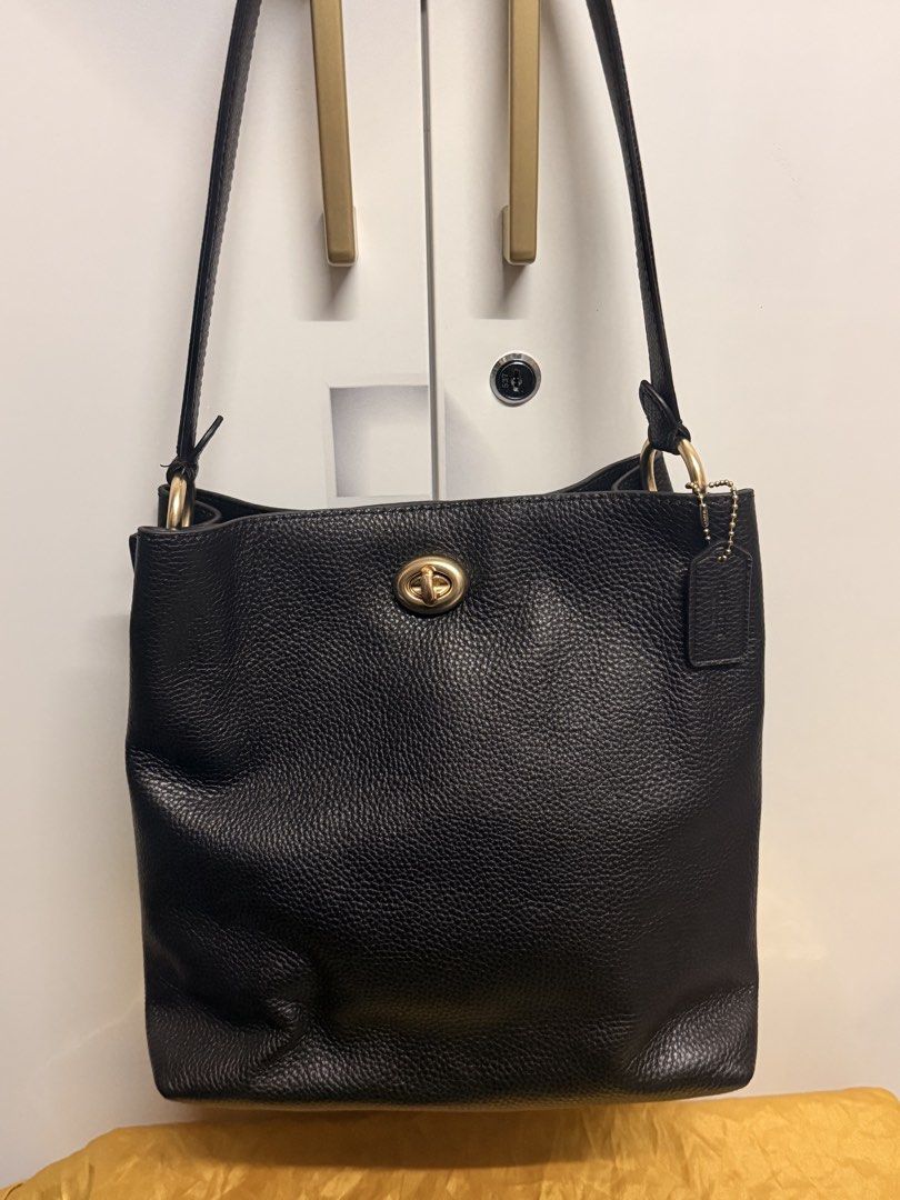 Coach Black Leather Shoulder Bag (Category: Luxury Bags & Wallets) located in Zamboanga. Submitted by bags2bags2bags (Listing ID 1465982048, Image 2). Description: - Brand: Coach - Material: Premium black pebbled leather - Hardware: Polished gold-tone with classic turnlock closure - Style: Minimalist bucket shoulder bag with single strap - Inclusion: Signature Coach leather hangtag - Interior: Roomy and spacious for everyday essentials - Conditio