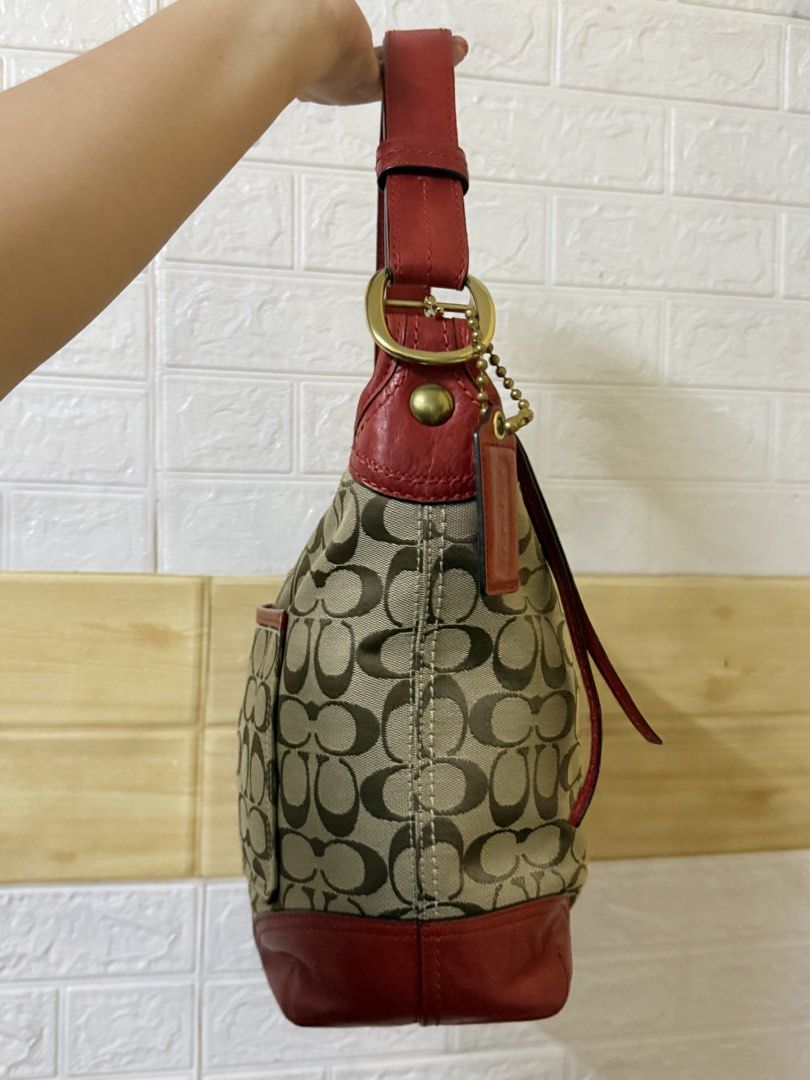 Coach Bucket NEW CONDITION (Category: Luxury Bags & Wallets) located in Manila. Submitted by angelcurated (Listing ID 1465974521, Image 3). Description: - Brand: Coach - Material: Signature C jacquard fabric with red leather trim and base corners - Hardware: Gold-tone - Exterior: Front slip pocket and classic embossed hangtag - Strap: Adjustable red leather shoulder strap - Interior: Spacious with sturdy stitching - Condition: Great everyday bag 