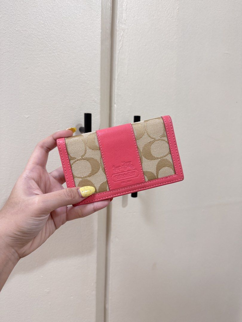fixrd price Coach Card Holder Pink (Category: Wallets & Card holders) located in Manila. Submitted by livelaughlovejay (Listing ID 1466065386, Image 1). Description: - Brand: Coach - Material: Signature tan canvas with vibrant pink leather trim - Design: Center pink leather band with embossed Coach logo and horse and carriage motif - Features: Contrast pink stitching along edges, compact size - Fit: Easily fits in small bags or pockets - Conditio