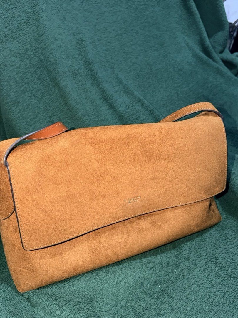 Coach Chelsea 30 suede (Category: Luxury Bags & Wallets) located in Makati City. Submitted by hearts0214 (Listing ID 1466111331, Image 2). Description: - Authentic Coach shoulder bag in luxurious tan brown suede - Classic flap closure with subtle Coach New York branding - Comfortable single top handle with side ring attachments - Includes matching suede hangtag on a beaded chain - Structured side panels with clean, premium stitching details throu