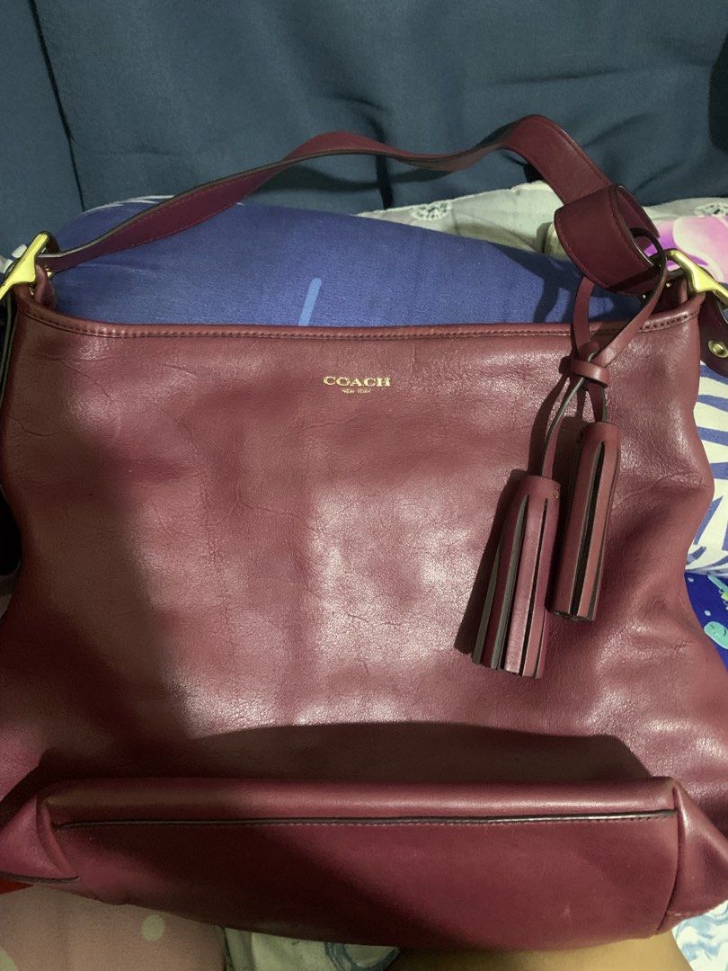 Coach Leather Shoulder Bag Burgundy (Category: Luxury Bags & Wallets) located in Bulacan. Submitted by celinexxxbuyer (Listing ID 1466131594, Image 2). Description: - Brand: Coach - Style: Leather shoulder bag in a rich burgundy color - Hardware & Accents: Gold-tone hardware with matching tassels - Closure: Top zip closure - Interior: Fabric lining with one zipper pocket and slip pockets - Authenticity: Coach creed patch with serial number C1375-