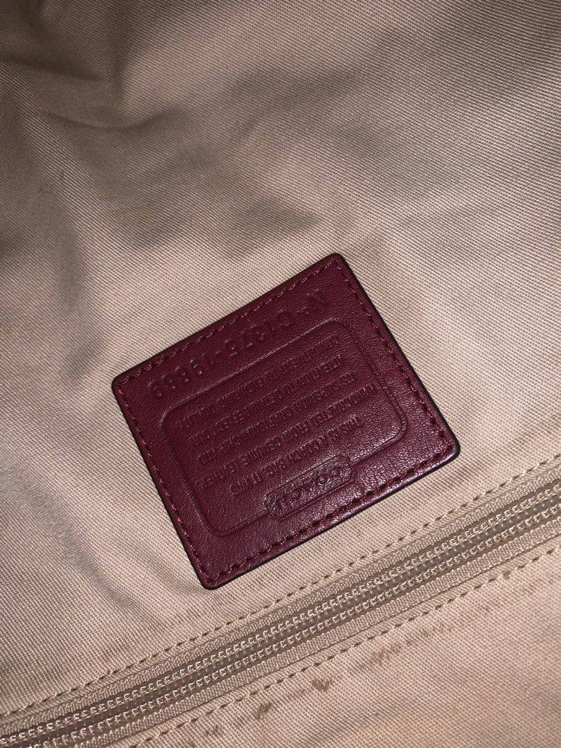 Coach Leather Shoulder Bag Burgundy (Category: Luxury Bags & Wallets) located in Bulacan. Submitted by celinexxxbuyer (Listing ID 1466131594, Image 3). Description: - Brand: Coach - Style: Leather shoulder bag in a rich burgundy color - Hardware & Accents: Gold-tone hardware with matching tassels - Closure: Top zip closure - Interior: Fabric lining with one zipper pocket and slip pockets - Authenticity: Coach creed patch with serial number C1375-