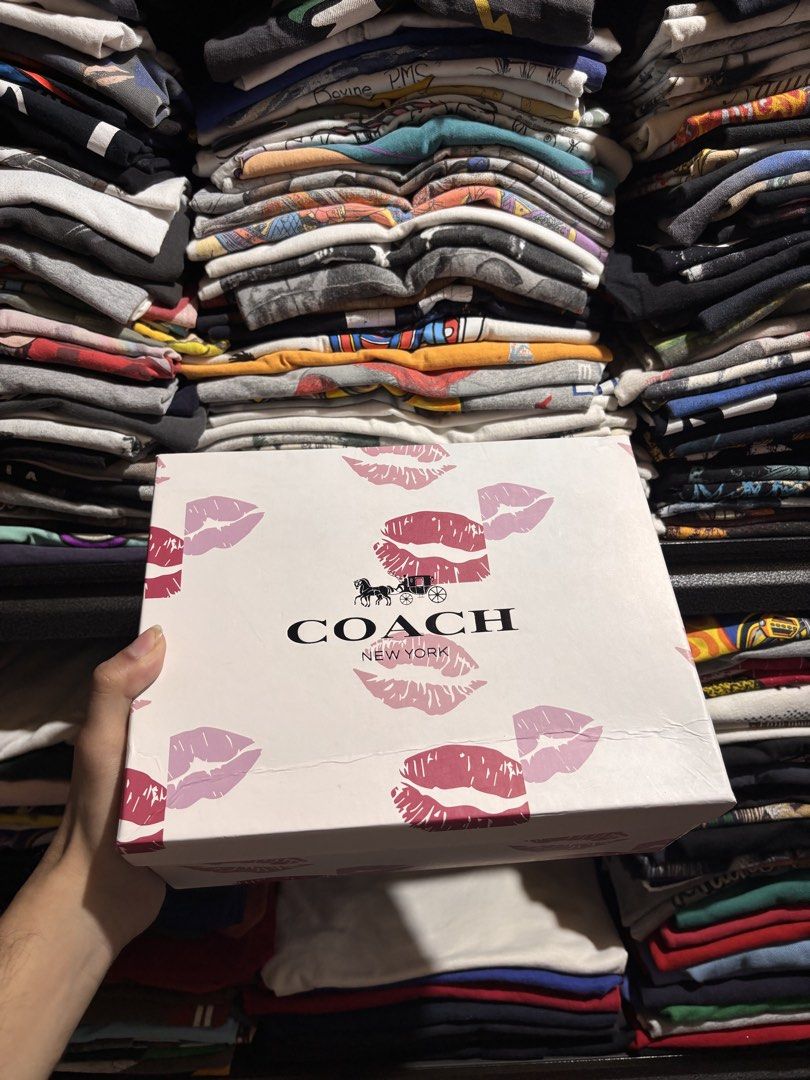 Coach Pink Signature Shoulder Bag (Category: Luxury Bags & Wallets) located in General Santos City (Dadiangas). Submitted by andrei_ciocon (Listing ID 1466093488, Image 2). Description: - Brand new, never used Coach shoulder bag - Pink signature monogram pattern with gold-tone hardware - Adjustable strap with original protective wrapping intact - Structured design with secure zip closure - Includes a special Coach gift box decorated with fun lip 