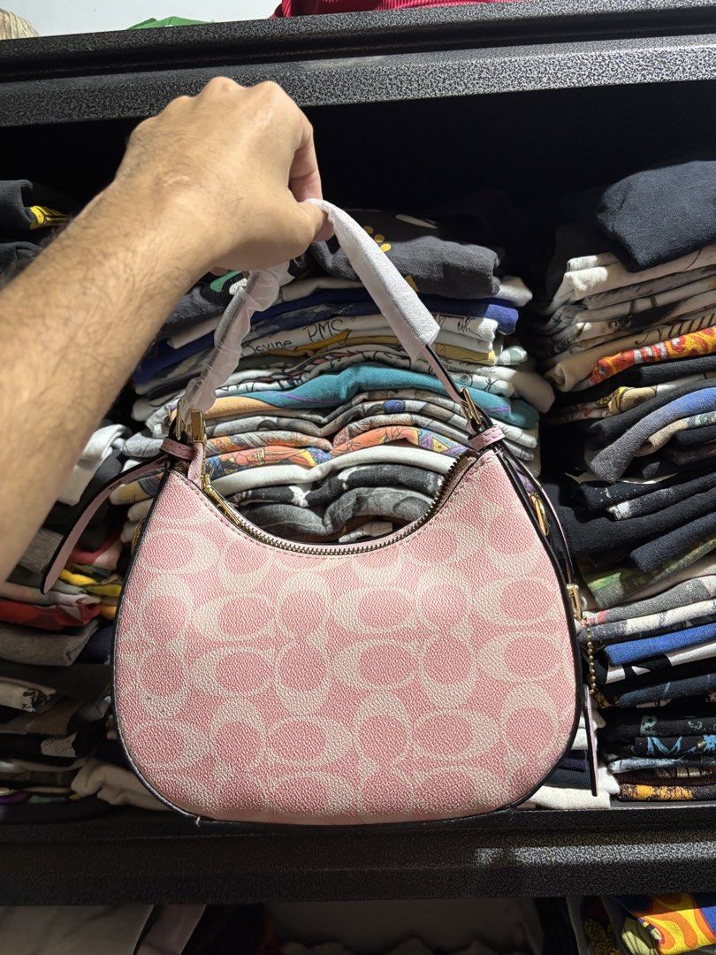 Coach Pink Signature Shoulder Bag (Category: Luxury Bags & Wallets) located in General Santos City (Dadiangas). Submitted by andrei_ciocon (Listing ID 1466093488, Image 3). Description: - Brand new, never used Coach shoulder bag - Pink signature monogram pattern with gold-tone hardware - Adjustable strap with original protective wrapping intact - Structured design with secure zip closure - Includes a special Coach gift box decorated with fun lip 