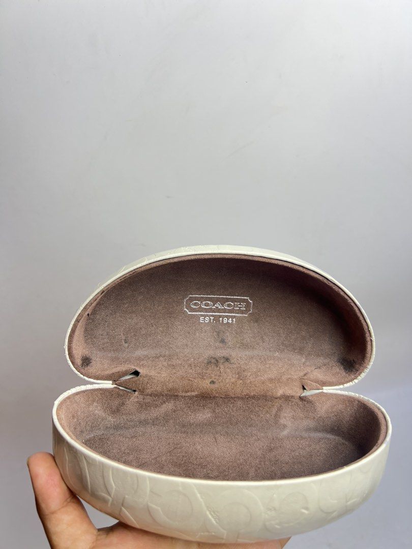 Coach signature C white hard shell sunglasses eyeglasses case (Category: Sunglasses & Eyewear) located in Baguio. Submitted by chiechie1234 (Listing ID 1466071237, Image 2). Description: - Coach hard shell glasses case - White exterior with iconic debossed signature C pattern - Luxurious brown suede interior lining with Coach Est. 1941 stamp - Secure and reliable magnetic snap closure - Excellent for keeping shades or specs safe in your bag - Con