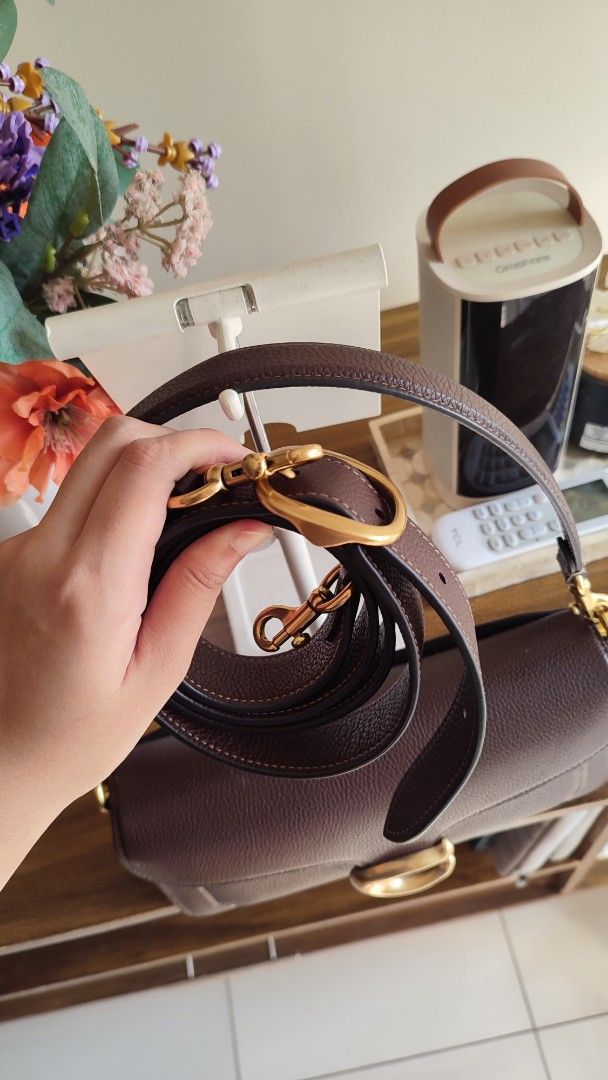Coach Tabby Shoulder Bag Brown Leather (Category: Luxury Bags & Wallets) located in Manila. Submitted by trishcaj (Listing ID 1465959185, Image 3). Description: - Authentic Coach tabby 26 shoulder bag in dark brown pebbled leather - Antique brass Signature C hardware on the front flap - Structured accordion-style design with 3 internal compartments and a zippered pocket - Clean interior lining featuring the embossed gold logo stamp - Versatile st