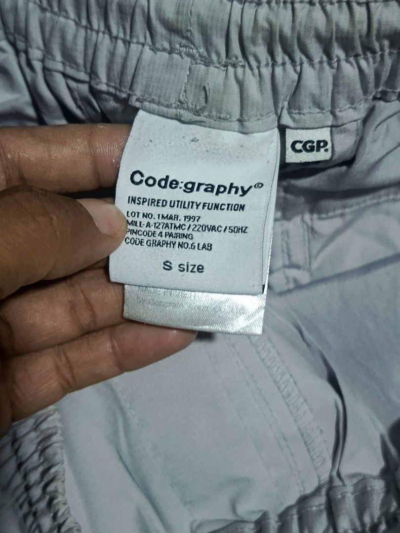 Code:graphy CGP Utility Function Shorts Light Grey Size S (Category: Shorts) located in City of Isabela. Submitted by warmbird.d06e6f (Listing ID 1465969726, Image 3). Description: - Brand/Model: Code:graphy Utility Shorts - Color: Light Grey - Size: S (Waist: 14-15 inches laid flat) - Fit: Elastic waistband with adjustable drawstring closure - Details: Front utility loop, back pockets with CGP logo patch - Style: Techwear aesthetic featuring ind