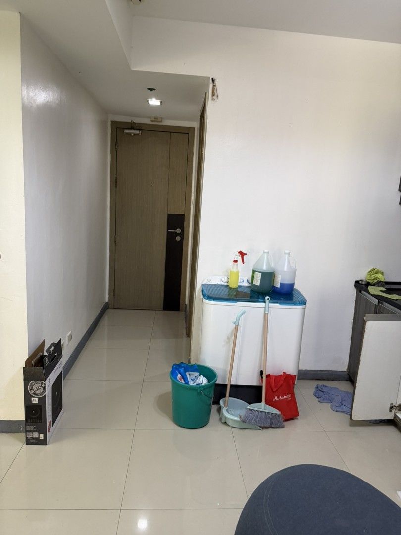 Condo Unit with Kitchenette, Bedroom, and Bathroom (Category: Apartments & Condos) located in Manila. Submitted by epicmountain.05472a (Listing ID 1466061906, Image 3). Description: - Studio unit setup with full kitchenette, wooden cabinets, and stainless steel refrigerator - Separate bedroom area with double bed, mattress, and built-in wardrobe with mirror - Window AC unit already installed in the bedroom - Bathroom equipped with a glass shower 
