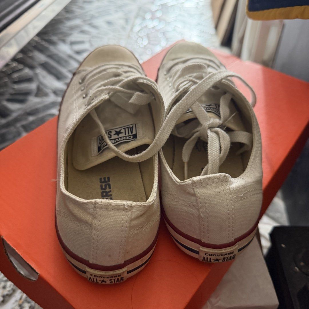 Converse All Star Low Top White Canvas Sneakers (Category: Sneakers) located in Manila. Submitted by basiliocla11530 (Listing ID 1466012024, Image 2). Description: - Brand: Converse All Star - Style: Low top canvas sneakers in classic white - Details: Lace-up front, metal eyelets, signature rubber toe cap - Condition: Notable discoloration, yellowish glue stains along sole edges, and scuffing on toe caps - Usage: Still has plenty of life left for
