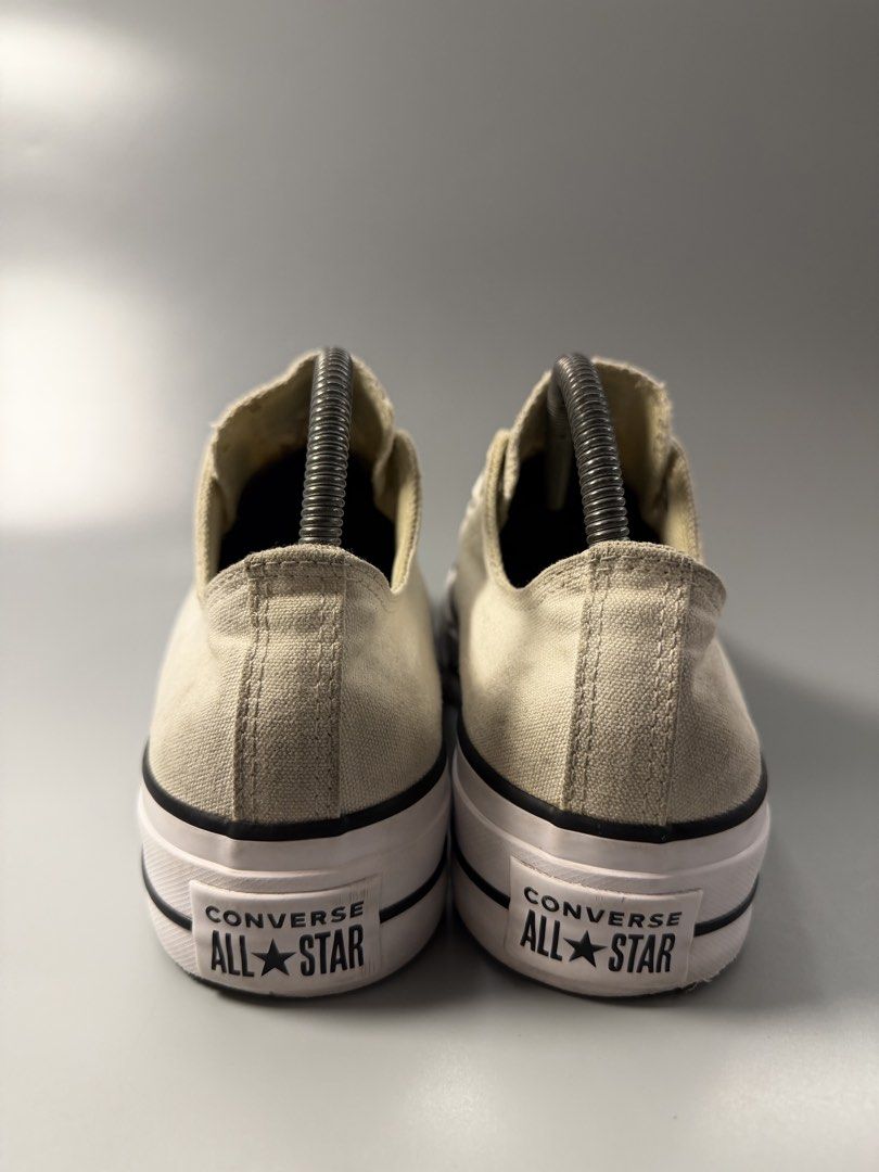 Converse All Star Platform Low Top Sneakers Off White (Category: Sneakers) located in Quezon City. Submitted by markieexp (Listing ID 1466092825, Image 3). Description: - Brand: Converse - Style: Off-white canvas low-top sneakers with thick platform sole - Details: Black piping along the midsole, white laces with metal eyelets, and classic brown rubber waffle outsoles - Condition: Casual everyday shoes, well-maintained with plenty of wear left in