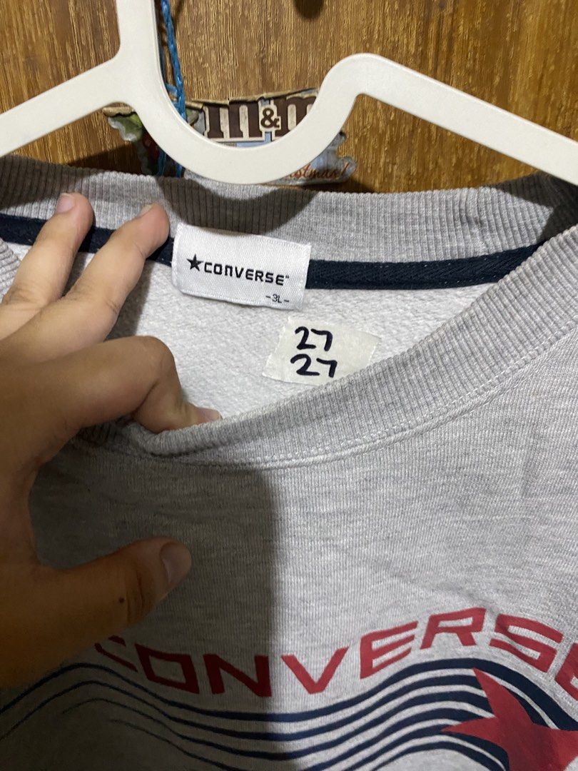 Converse Gray Crewneck Sweatshirt Size 3L (Category: Coats, Jackets and Outerwear) located in Imus. Submitted by frootiloots4103 (Listing ID 1466033674, Image 2). Description: - Color: Gray - Size: 3L 27x27 - Design: Large Converse chest graphic with blue motion lines and red star - Material: Comfortable fleece interior - Features: Ribbed collar, cuffs, and hem - Condition: Excellent pre-loved condition - Mode of Payment: GCash or BPI - Shipping: