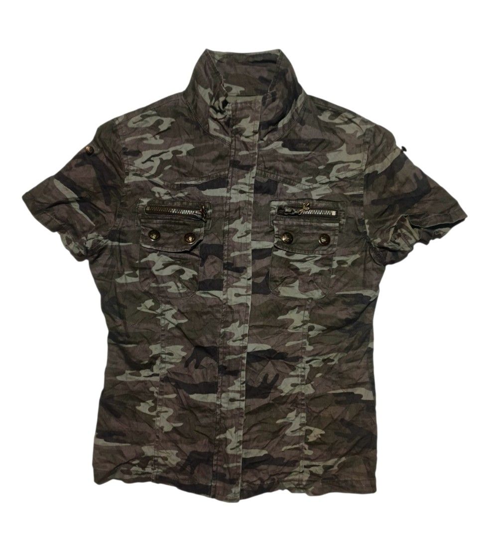 Cornflake Camouflage Zip Up (Category: Coats, Jackets and Outerwear) located in Calabanga. Submitted by bekneegear (Listing ID 1466123159, Image 1). Description: - Style: Rugged military-inspired utility camo jacket - Color: Green and brown cornflake camo tones - Design: Short sleeves, front zipper closure, and high collar neckline - Pockets & Details: Dual chest pockets with zipper accents, decorative metal pull tabs, and antique bronze buttons 