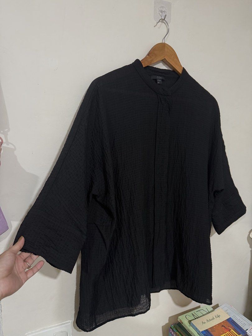 COS oversized black Linen Top (Category: Blouses) located in Manila. Submitted by morningthrifters (Listing ID 1466101521, Image 2). Description: This COS Collarless Seersucker Shirt is a minimalist, oversized top designed for comfort and effortless style. Xs on tag but can actually fits Large frame • Fabric & Texture: Crafted from a lightweight crinkled seersucker fabric that gives it a distinct puckered texture and a relaxed, breezy drape. • Co