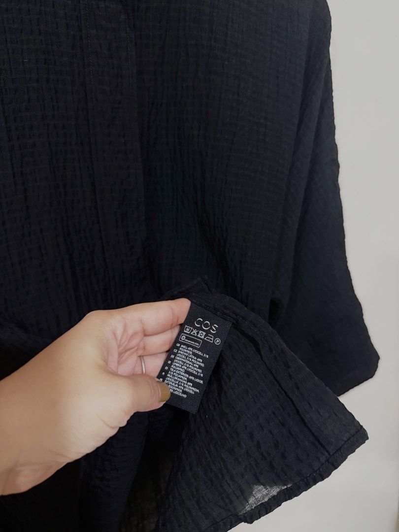 COS oversized black Linen Top (Category: Blouses) located in Manila. Submitted by morningthrifters (Listing ID 1466101521, Image 3). Description: This COS Collarless Seersucker Shirt is a minimalist, oversized top designed for comfort and effortless style. Xs on tag but can actually fits Large frame • Fabric & Texture: Crafted from a lightweight crinkled seersucker fabric that gives it a distinct puckered texture and a relaxed, breezy drape. • Co