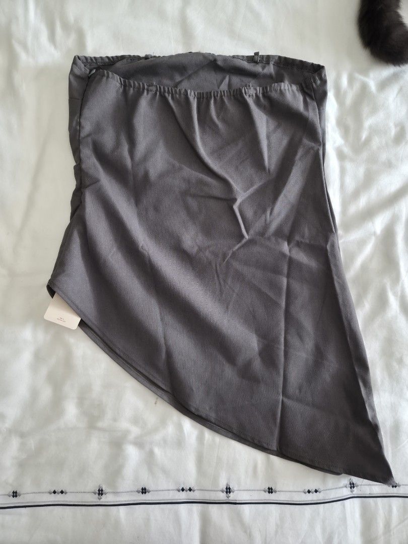 Cosmina Asymmetrical Strapless Gray Top Size M (Category: Sleeveless) located in Quezon City. Submitted by corrnic (Listing ID 1466033678, Image 3). Description: - Brand: Cosmina - Color: Gray - Size: Medium (Made in China), fits large - Condition: Brand new with original tags, never worn - Design: Strapless tube top with a unique asymmetrical curved hemline - Closure: Side zipper - Extras: Includes unused clear straps still in plastic packaging.