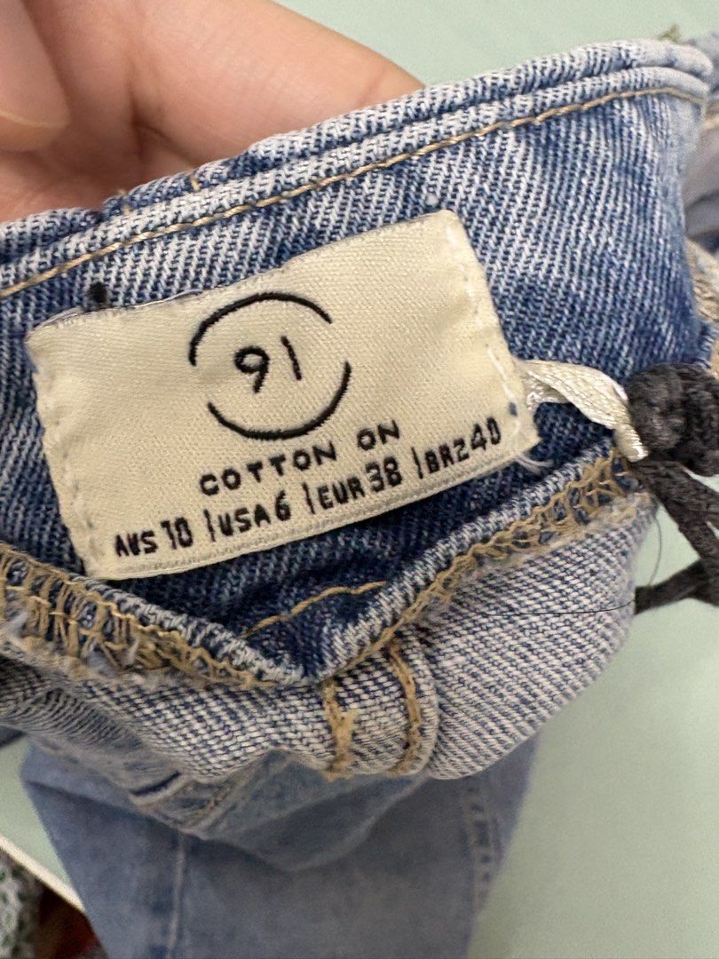 Cotton On Denim Skirt Size M (Category: Skirts) located in San Juan City. Submitted by moon.riverandme (Listing ID 1466112477, Image 2). Description: - Brand: Cotton On - Style: Denim skirt with front button-down closure and classic panel detailing - Wash: Medium blue - Size: AUS 10, USA 6, EUR 38, BR 40 - Pockets: Two functional front pockets - Condition: Good, with minor fraying thread at the inside waistband edge (unnoticeable when worn) .