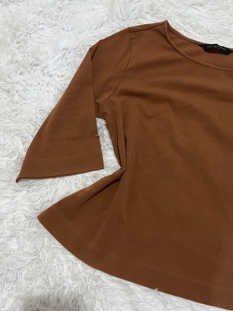 Cotton Tree Brown Medium Top (Category: Blouses) located in Tuguegarao City. Submitted by love_clothies (Listing ID 1465994619, Image 2). Description: - Brand: Cotton Tree - Size: Medium - Color: Brown - Neckline: Round neckline - Sleeves: Half-length sleeves - Design: Flare hem detail at the bottom - Style: Versatile everyday piece, easy to match with jeans or skirts.