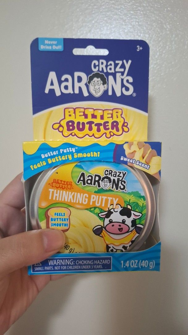Crazy Aaron's Better Butter Thinking Putty 1.4 oz (Category: Kids Toys) located in Pasay City. Submitted by mshannahpi (Listing ID 1465967952, Image 1). Description: - Brand: Crazy Aaron's Thinking Putty - Scent/Color: Better Butter (Sweet scent, yellow putty) - Size: 1.4 oz / 40 grams - Packaging: Includes metal tin and original outer cardboard box - Features: Never dries out, super smooth and buttery texture - Recommended Age: 3 years old and u