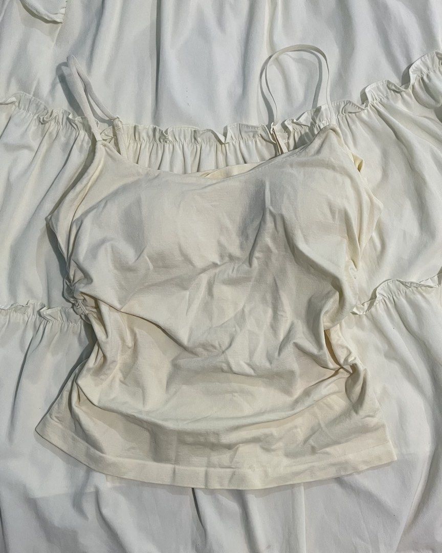 Cream Built-In Bra Cami Top (Category: Sleeveless) located in Kapalong. Submitted by elleclo (Listing ID 1466049322, Image 1). Description: - Features: Built-in padded bra cups, thin adjustable shoulder straps - Material: Soft and stretchy cotton-blend fabric - Condition: Excellent, clean with no stains or flaws - Perfect for layering or everyday wear.