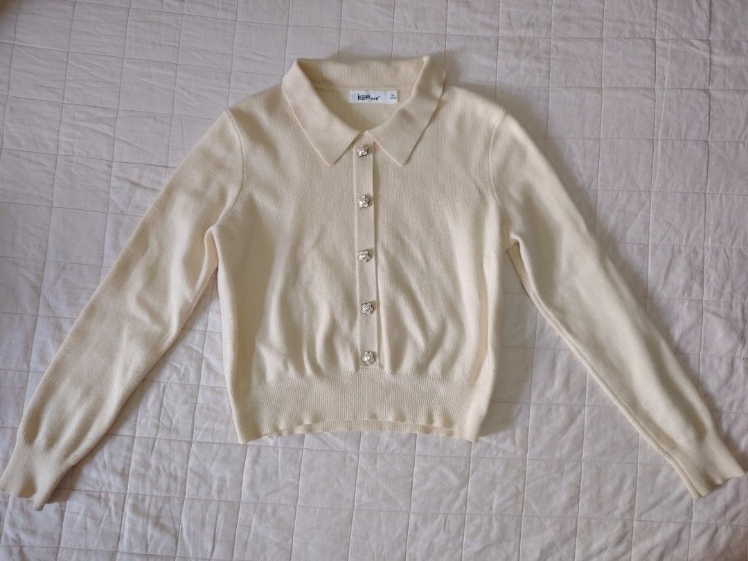 Cream Collared Knitted Sweater With Flower Buttons (Category: Longsleeves) located in Tarlac. Submitted by your_finds (Listing ID 1465998175, Image 1). Description: Description: - S-M ang size - Color cream - Design lang ang buttons Condition: 8/10 / Good condition Issue: Himulmol at stain Medida size (inch) Bust: 34-37 Length: 18.5.