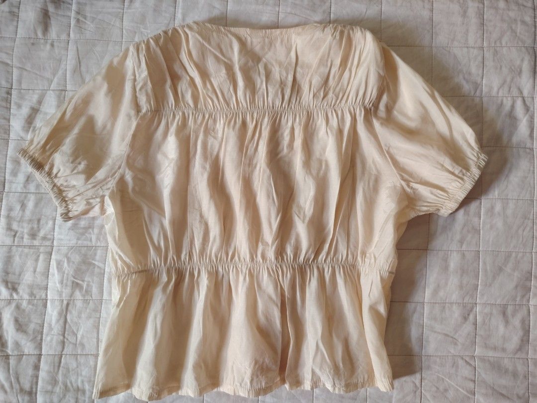 Cream Color Short-Sleeve Button-Down Blouse (Category: Blouses) located in Tarlac. Submitted by your_finds (Listing ID 1466003398, Image 2). Description: Description: - S-M ang size - Color cream - Working ang buttons - Stretchable ang armholes at ang waist part - May pagka shiny ang tela - Pinalitan ang isang button Condition: 9/10 / Very good condition Medida size (inch) Bust: 35 Length: 19.