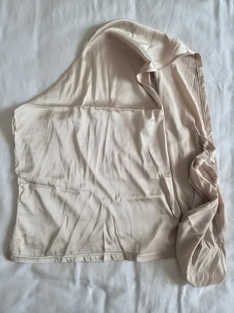 Cream One-Shoulder Draped Top with Long Sashes (Category: Sleeveless) located in Quezon City. Submitted by corrnic (Listing ID 1466039424, Image 2). Description: - Color: Cream - Style: Chic one-shoulder top with flowing sashes - Material: Soft and stretchy fabric - Details: Gathered bodice, asymmetrical look - Condition: Great, worn only a few times - Styling: Easily pairs with shorts or trousers.