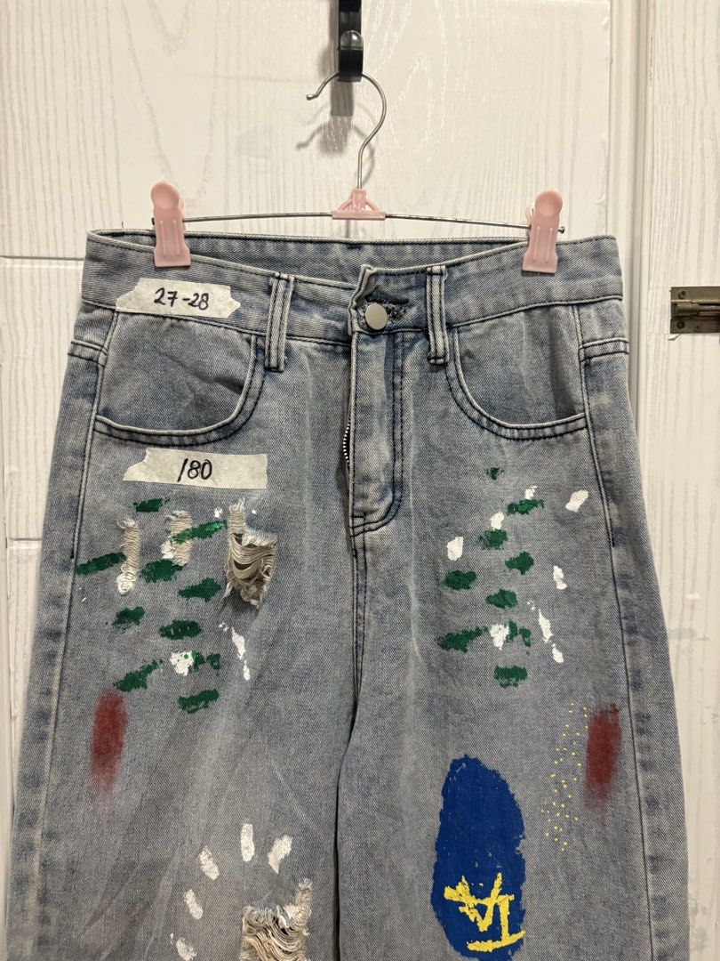 Custom Painted Ripped Jeans Size 27-28 (Category: Jeans) located in Mandaluyong City. Submitted by shopwithjuu (Listing ID 1466053011, Image 2). Description: Size 27-28 Light wash mid-rise denim jeans featuring custom paint splatters and distressed knee rips. A fun streetwear staple with colorful accents on the front and back. Button and zipper closure..