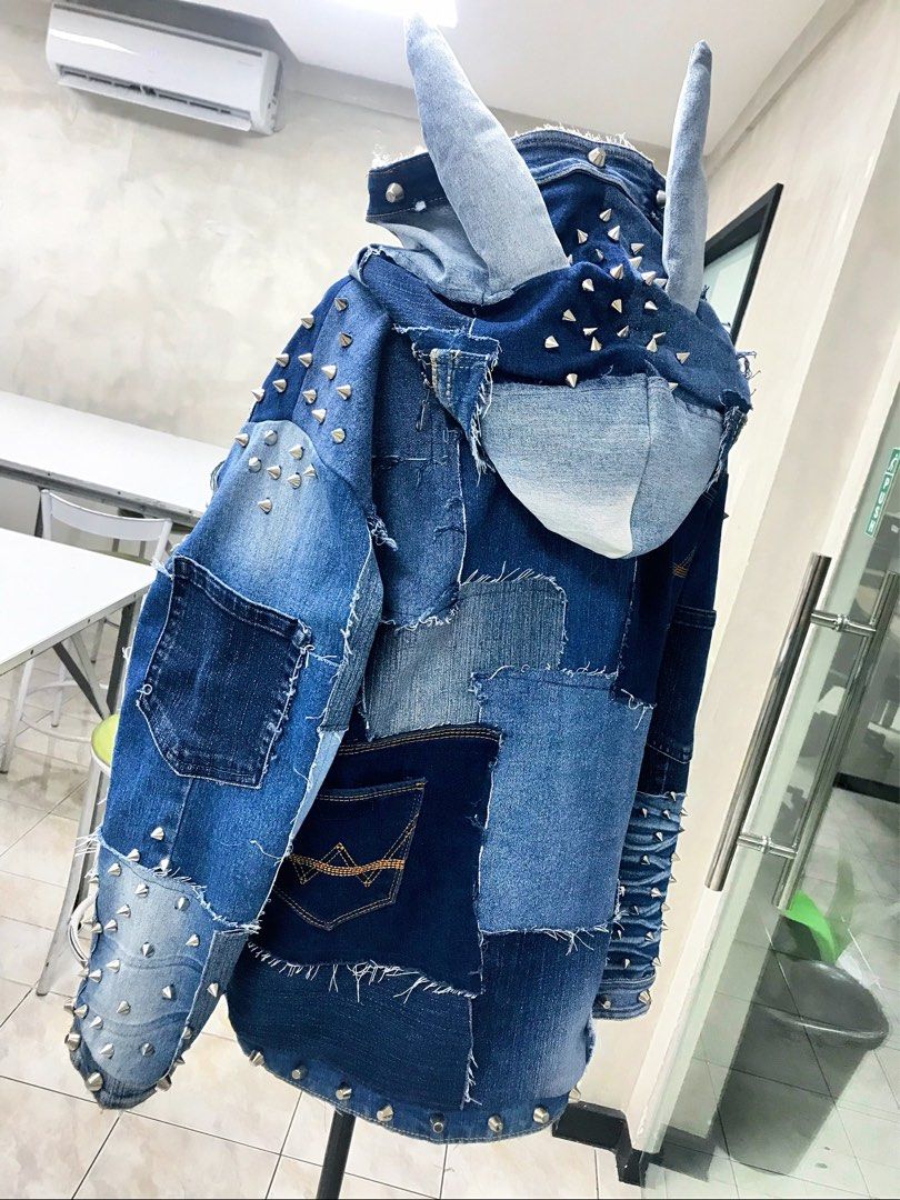 Custom Studded Denim Patchwork Jacket with Hood and Horns (Category: Coats, Jackets and Outerwear) located in Taguig. Submitted by aphroditexelliz08 (Listing ID 1466135616, Image 1). Description: • Custom Designer made heavy denim jacket with a unique patchwork design • Features metal spike studs along the sleeves, hood, and hem • Built-in hood includes two fabric bunny ears and a small zipped pocket detail • Accented with multiple mismatched den