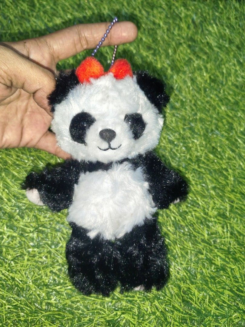Cute Panda Plush Keychain with Red Bow (Category: Plushies & Soft Toys) located in Paranaque City. Submitted by furugiyafinds (Listing ID 1466108453, Image 1). Description: - Adorable fluffy panda plush keyring - Soft black and white fur with vibrant red pompoms - Features a sturdy purple beaded chain - Great for decorating bags, backpacks, or keys - Brand new and ready to ship.