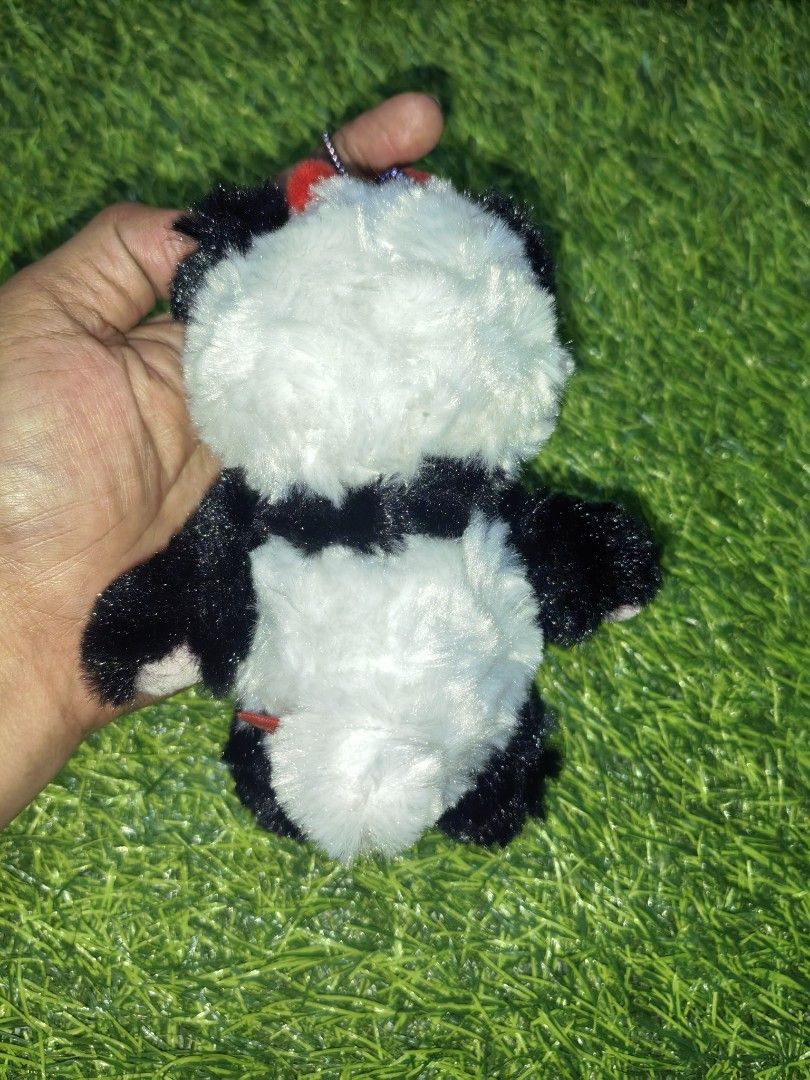 Cute Panda Plush Keychain with Red Bow (Category: Plushies & Soft Toys) located in Paranaque City. Submitted by furugiyafinds (Listing ID 1466108453, Image 2). Description: - Adorable fluffy panda plush keyring - Soft black and white fur with vibrant red pompoms - Features a sturdy purple beaded chain - Great for decorating bags, backpacks, or keys - Brand new and ready to ship.