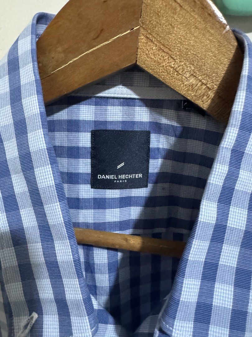 Daniel Hechter Paris Blue Gingham Button-Down Shirt (Category: Tshirts & Polo Shirts ) located in Taguig. Submitted by declutteringbyalexis (Listing ID 1466027566, Image 2). Description: - Brand: Daniel Hechter Paris - Style: Short-sleeve button-down shirt - Pattern: Classic blue and white checkered - Features: Standard collar, front button closure, one left chest pocket - Quality: Clean stitching and premium fabric - Ideal for: Casual daily wear