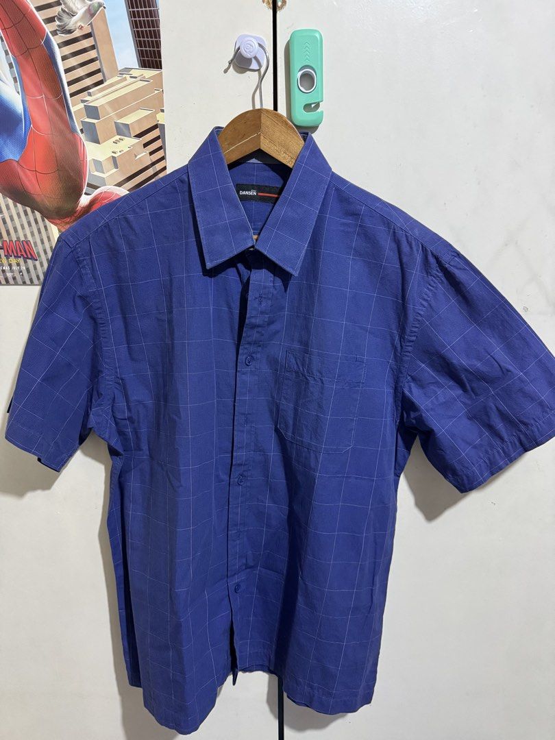 Dansen Blue Grid Short Sleeve Button-Down Shirt (Category: Shirts) located in Taguig. Submitted by declutteringbyalexis (Listing ID 1466027449, Image 1). Description: - Brand/Style: Dansen short sleeve button-down shirt - Color/Pattern: Blue with a subtle grid check design - Features: Left chest pocket, standard collar, and front button closure - Versatility: Great for daily casual wear or office settings - Condition: Excellent / Ready to wear.