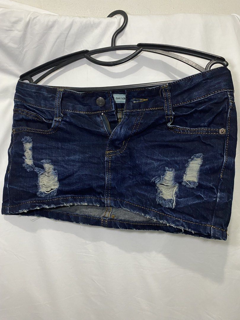 Dark wash distressed denim skirt (Category: Skirts) located in Manila. Submitted by lily0528 (Listing ID 1466150884, Image 1). Description: Medium W Waist 28-30 - Color: Dark blue denim - Design: Trendy ripped details with a stylish frayed hem - Features: Classic five-pocket styling, contrast stitching, front button, and zipper fly - Fit: Short length, great for pairing with basic tees or crop tops - Condition: Brand tag visible near waistband, p