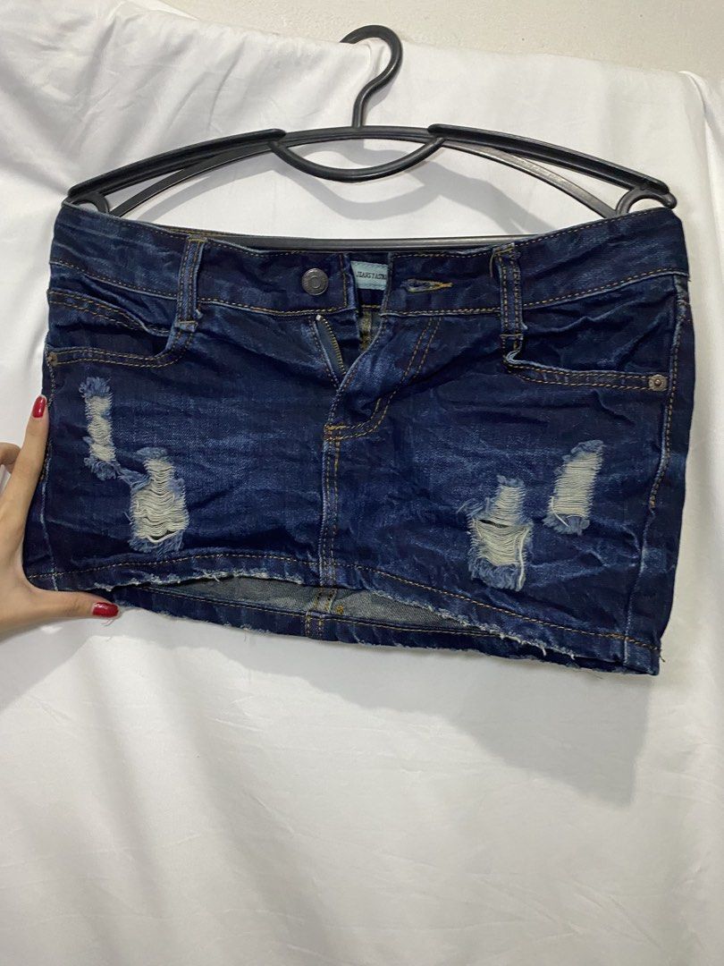 Dark wash distressed denim skirt (Category: Skirts) located in Manila. Submitted by lily0528 (Listing ID 1466150884, Image 2). Description: Medium W Waist 28-30 - Color: Dark blue denim - Design: Trendy ripped details with a stylish frayed hem - Features: Classic five-pocket styling, contrast stitching, front button, and zipper fly - Fit: Short length, great for pairing with basic tees or crop tops - Condition: Brand tag visible near waistband, p